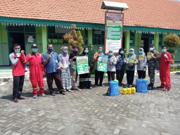 Babinsa Serka Muttakim tim Puskesmas Barengkrajan lakukan penyemprotan