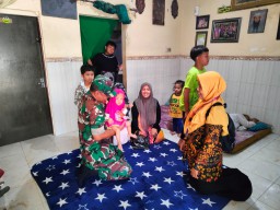 Babinsa Koramil 0816/16 Waru memberikan PMT untuk balita stunting di Desa Wadungasri